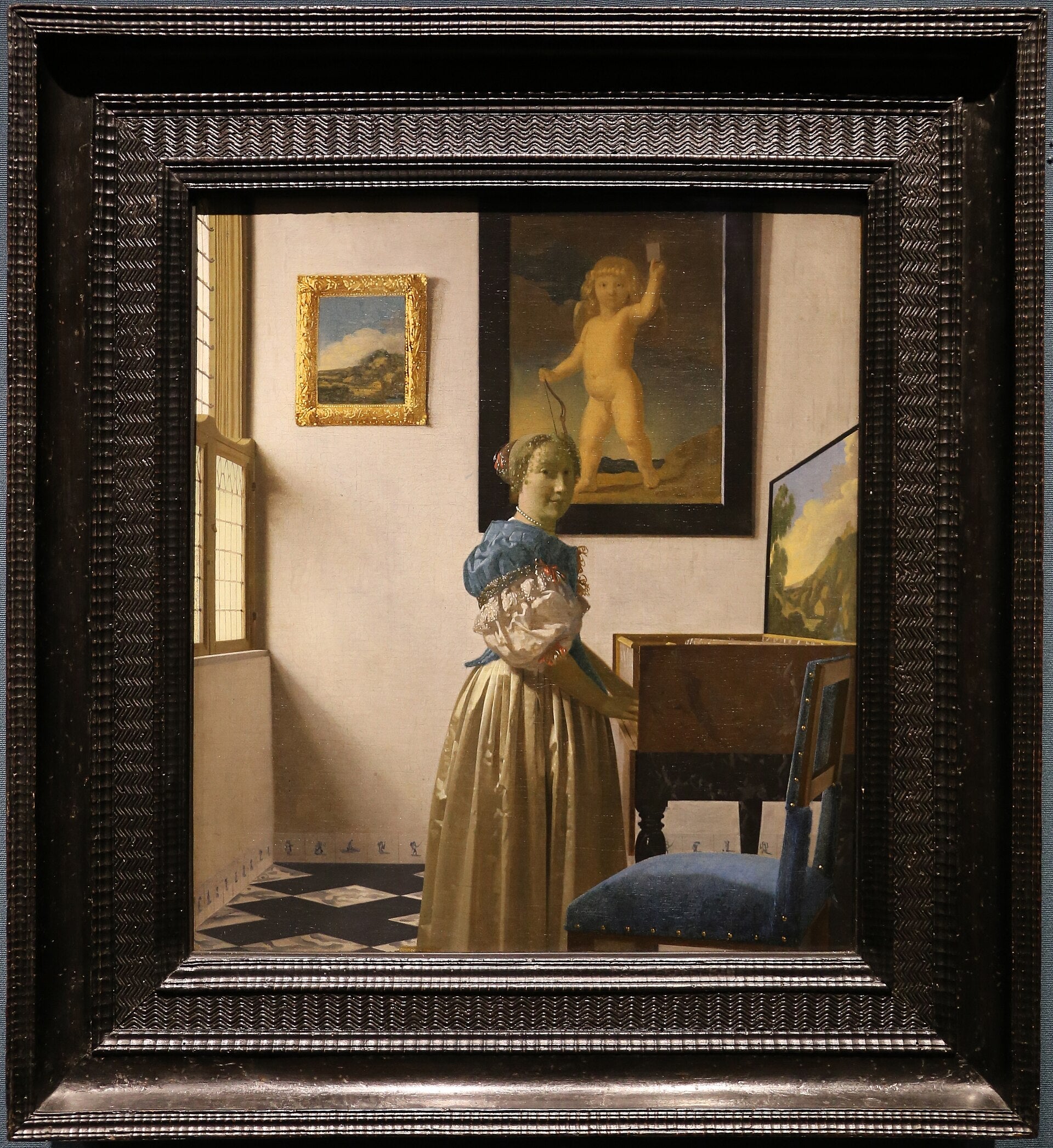 En dame stående ved virginalet - Johannes Vermeer